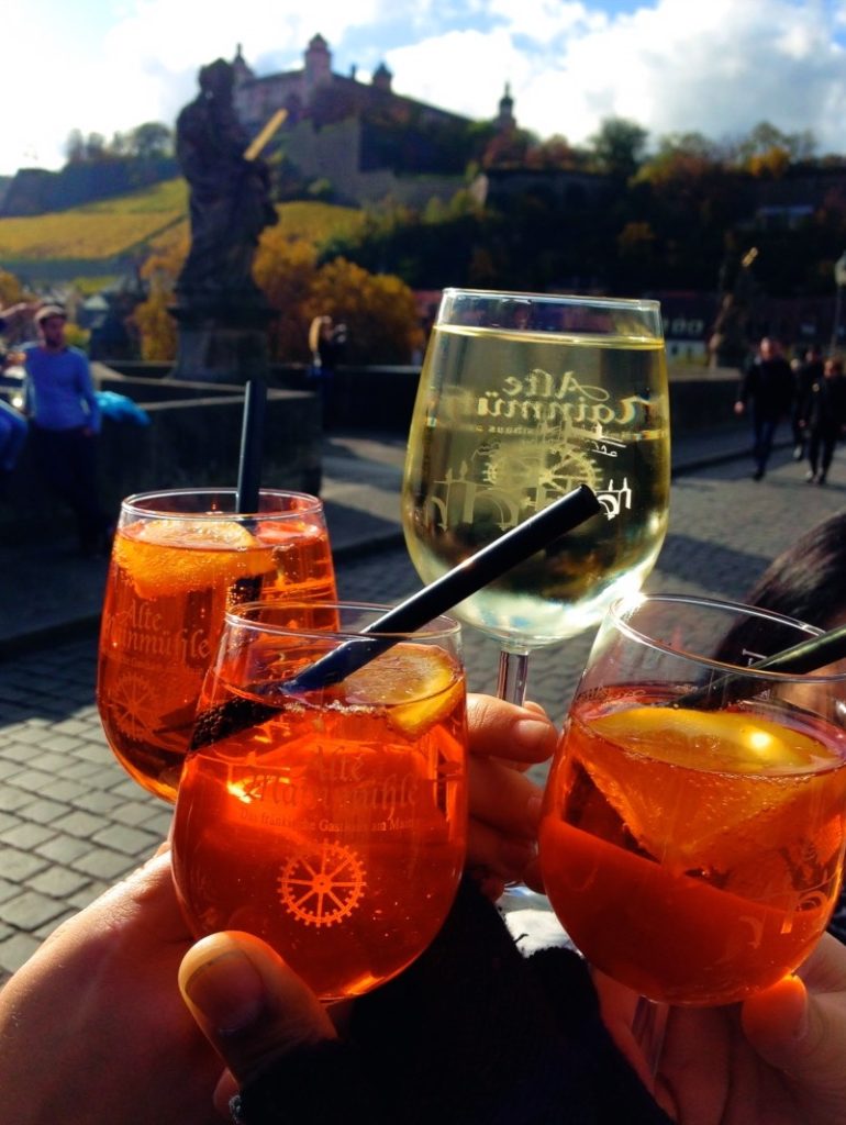 Treat yourself to an Aperol spritz or a glass of wine while strolling across the Würzburg bridge!