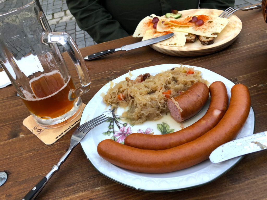 Three wurst sausage plate, bacon sauerkraut, bread and cheese at Kloine Zoigl Stub’n Zum Stich’n