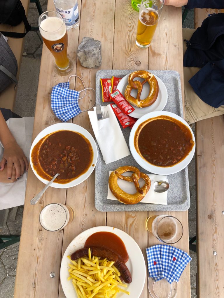 Goulash soup, currywurst with fries, pretzels, and beer at restaurant alpspitz