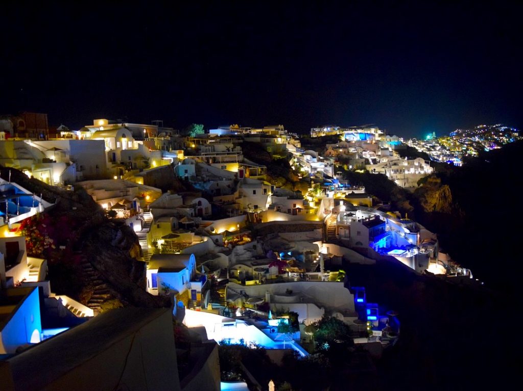 Classic shades of blue and yellow lights from Santorini in the evening