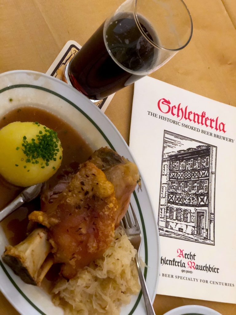 Pork knuckle, potato and smoke beer at schlenkerla restaurant in Bamberg Germany