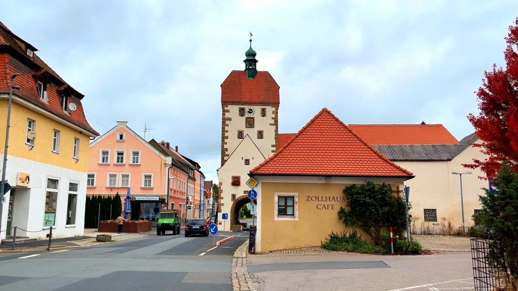 Cars driving by the Zollhaus and Vogelturm tower in Vilseck Germany