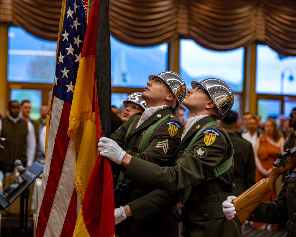 honor guard soldiers raising the American and German flags